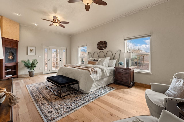 bedroom featuring access to outside, multiple windows, light wood-style flooring, and baseboards