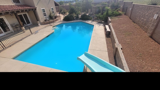 view of swimming pool featuring a fenced in pool, a fenced backyard, and a patio