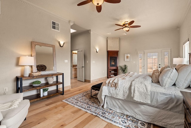 bedroom featuring access to exterior, visible vents, light wood-style flooring, ornamental molding, and baseboards