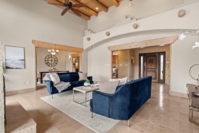 living room with arched walkways, a towering ceiling, wood ceiling, baseboards, and beamed ceiling