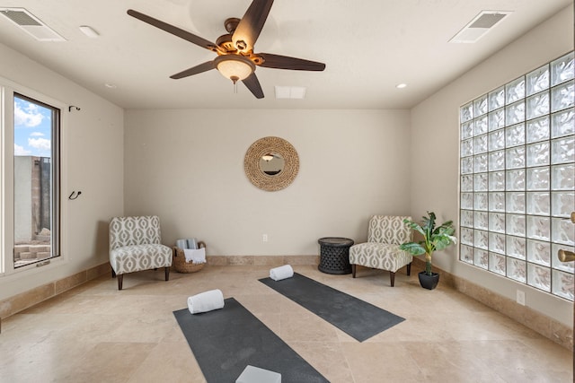 living area with visible vents, baseboards, and tile patterned floors