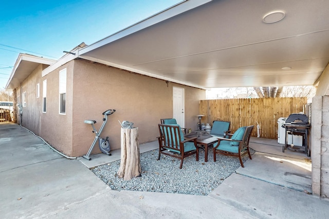 view of patio featuring fence and grilling area