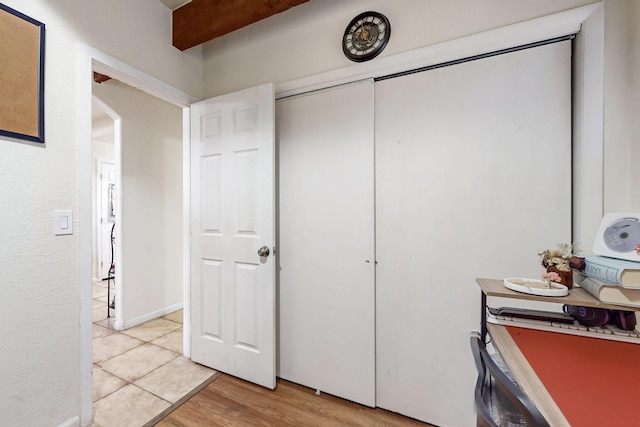 bedroom with light wood finished floors and a closet