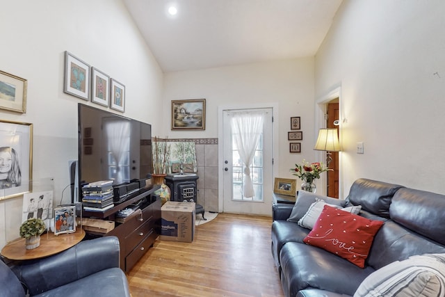 living area with high vaulted ceiling and light wood-style flooring