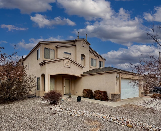 view of front of property featuring an attached garage and stucco siding