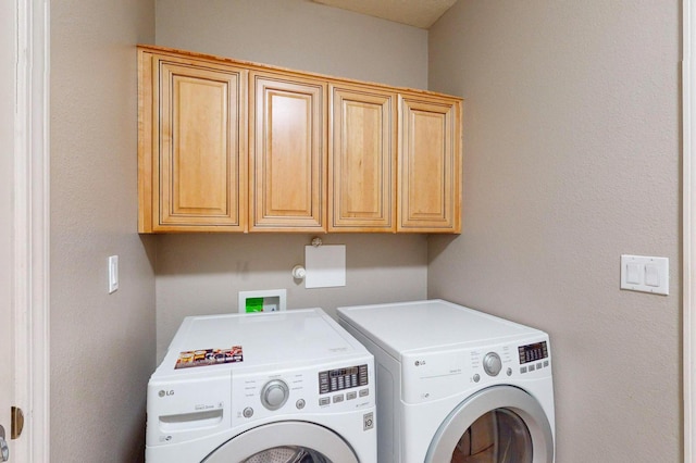 laundry area with washer and clothes dryer and cabinet space