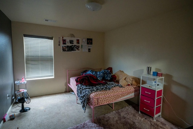 carpeted bedroom featuring visible vents and baseboards