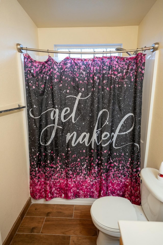 full bath with wood tiled floor, a shower with curtain, baseboards, and toilet