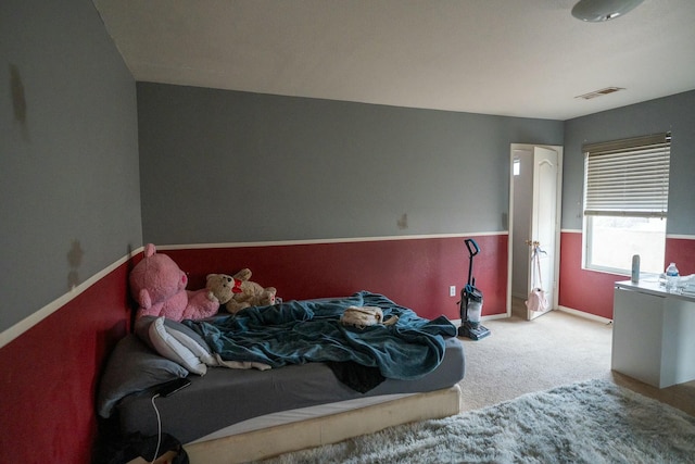 bedroom featuring carpet, visible vents, and baseboards