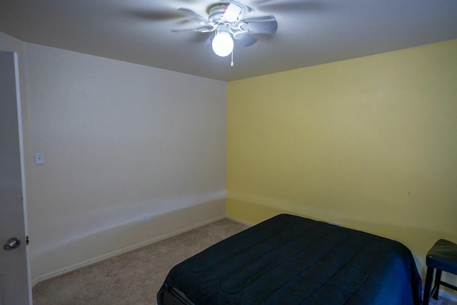 carpeted bedroom featuring a ceiling fan and baseboards