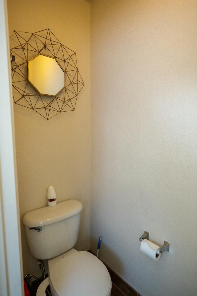 bathroom featuring toilet and baseboards