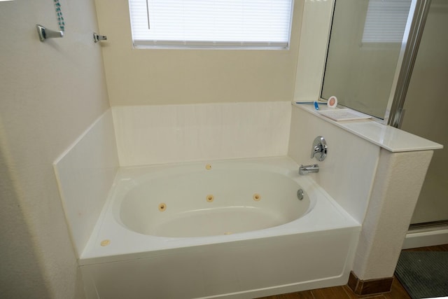 full bathroom featuring a whirlpool tub