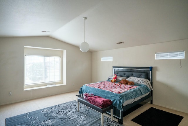 bedroom with lofted ceiling, carpet floors, baseboards, and visible vents