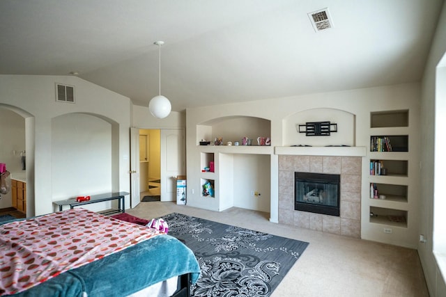 bedroom with carpet, visible vents, and vaulted ceiling