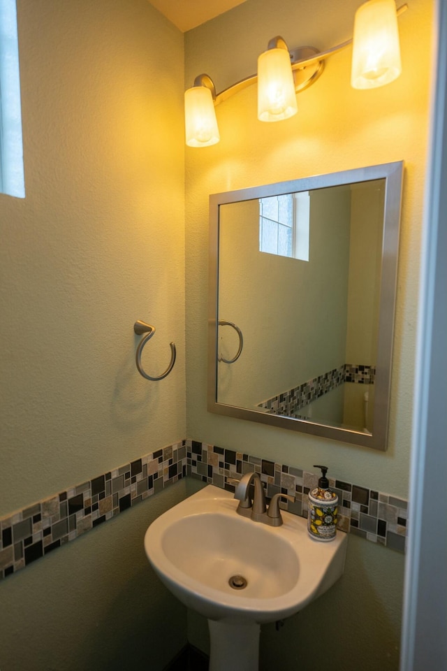 bathroom with backsplash and a sink