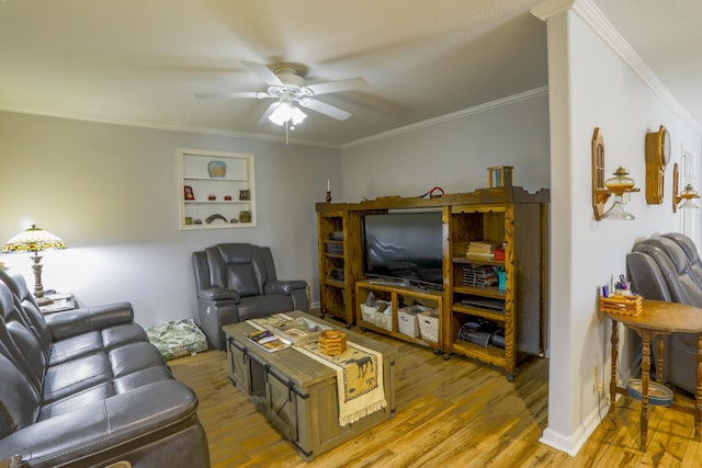 living area with baseboards, light wood-type flooring, a ceiling fan, and crown molding