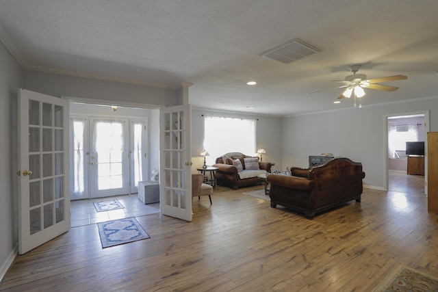 entryway featuring a wealth of natural light, french doors, visible vents, and wood finished floors