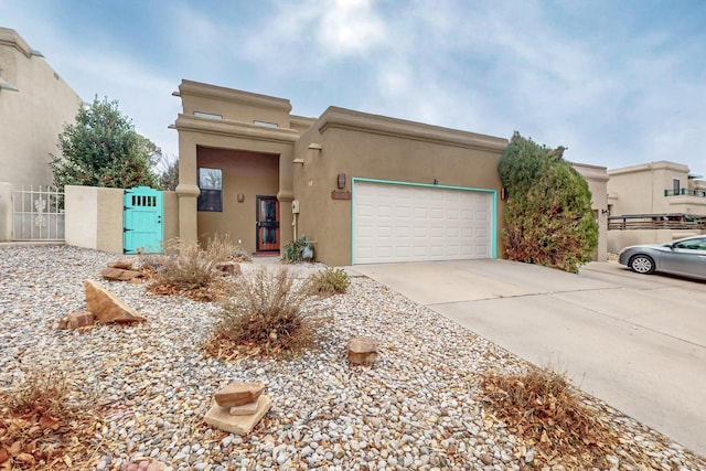 pueblo-style home with a garage