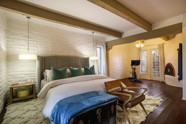 bedroom featuring dark wood-type flooring, brick wall, and beam ceiling