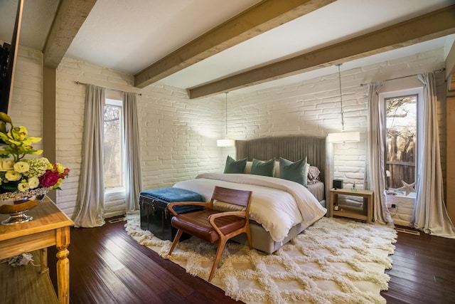 bedroom with multiple windows, beamed ceiling, dark hardwood / wood-style floors, and brick wall