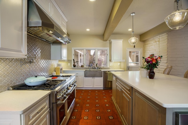 kitchen featuring appliances with stainless steel finishes, white cabinets, a center island, and range hood