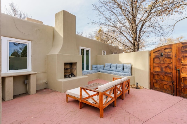 view of patio featuring an outdoor living space with a fireplace