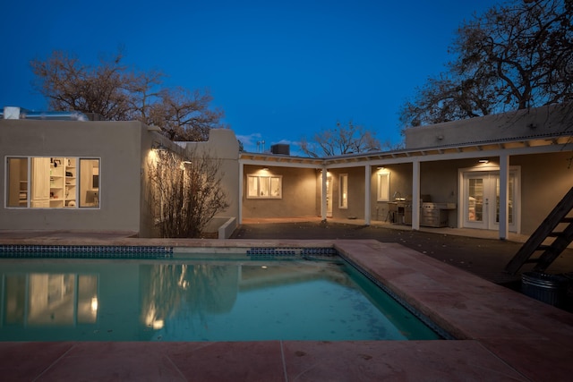 view of pool featuring a patio area and an outdoor kitchen