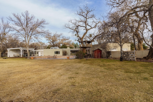 rear view of house featuring a lawn