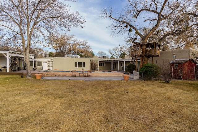 back of property with a patio and a lawn