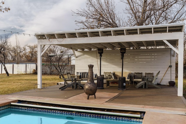 view of swimming pool with outdoor lounge area, a yard, and a deck