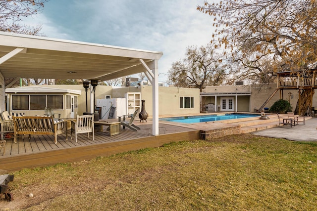 view of pool featuring a wooden deck and a patio