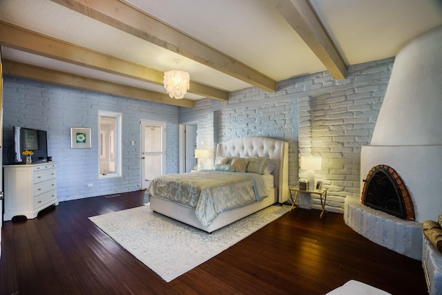 bedroom with dark hardwood / wood-style flooring, beamed ceiling, and a notable chandelier