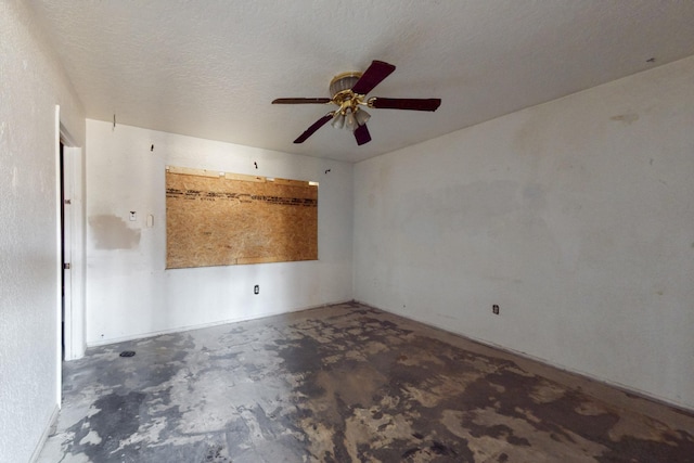 spare room featuring concrete floors and a textured ceiling