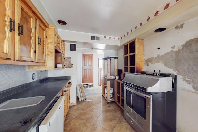 kitchen with a sink, visible vents, stainless steel range with electric cooktop, dishwasher, and dark countertops