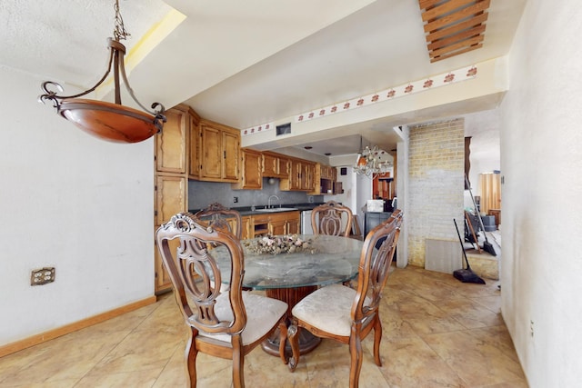 dining area with decorative columns, baseboards, and light tile patterned floors