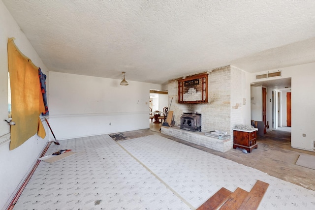 unfurnished living room featuring visible vents and a textured ceiling