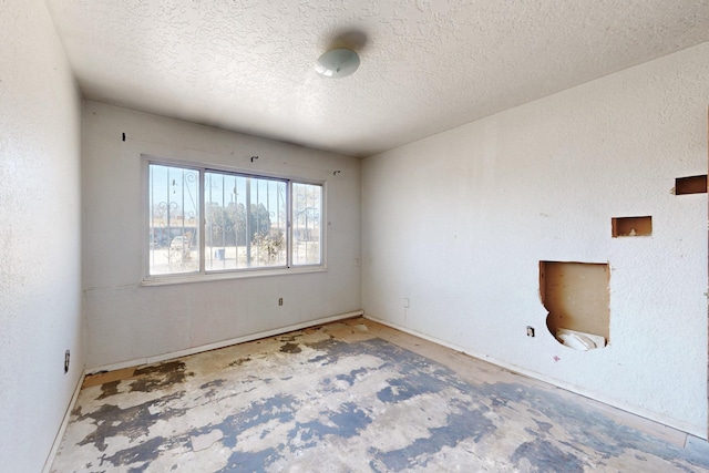 spare room with a textured ceiling