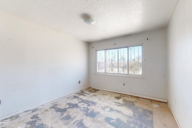 unfurnished room featuring a textured ceiling