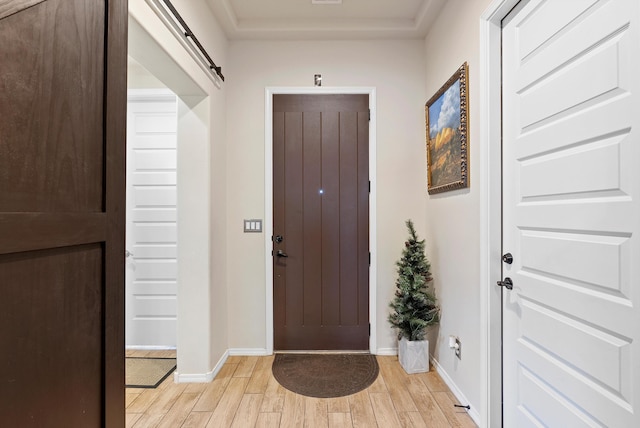 entrance foyer featuring light hardwood / wood-style flooring and a barn door