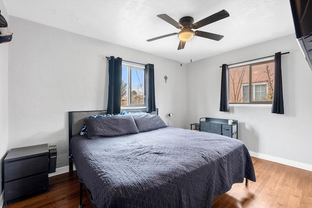 bedroom featuring ceiling fan and dark hardwood / wood-style floors