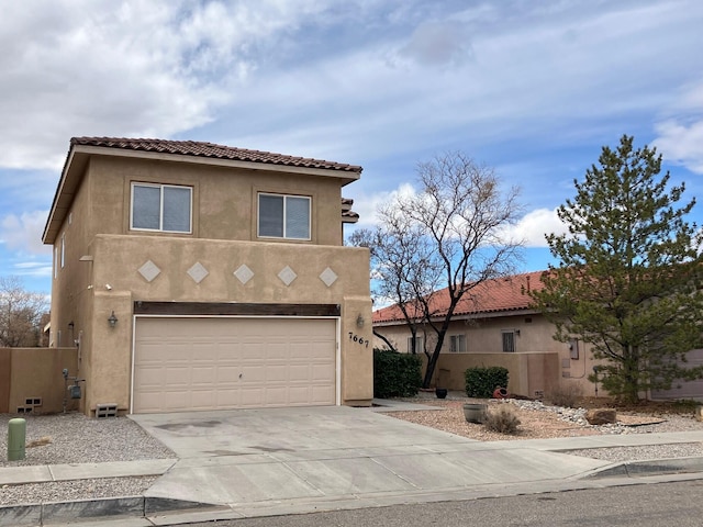 view of front facade featuring stucco siding, driveway, a tile roof, fence, and a garage