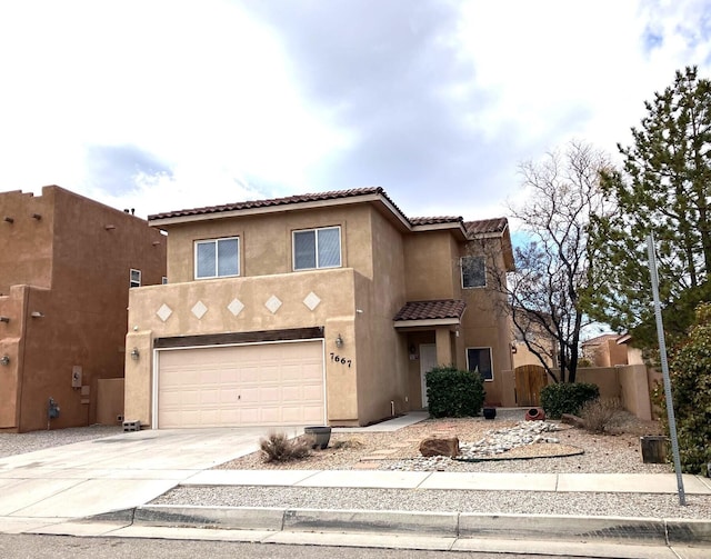 view of front of house with stucco siding, fence, concrete driveway, a garage, and a tiled roof