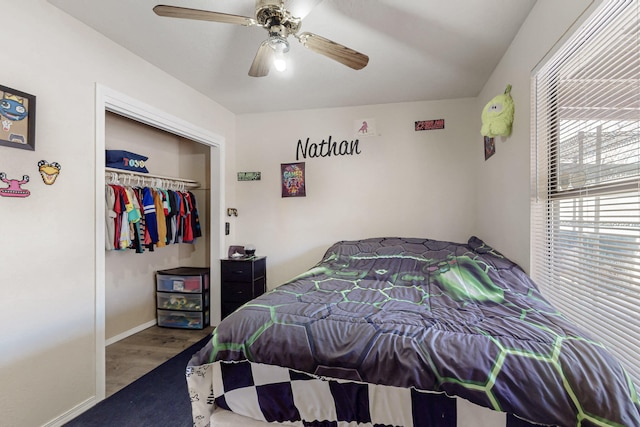 bedroom with hardwood / wood-style flooring, ceiling fan, and a closet
