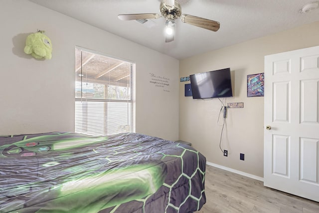 bedroom featuring ceiling fan and light hardwood / wood-style floors