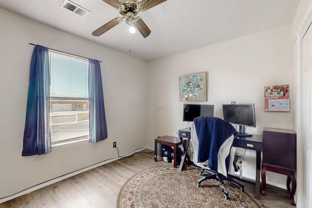 office with hardwood / wood-style flooring and ceiling fan