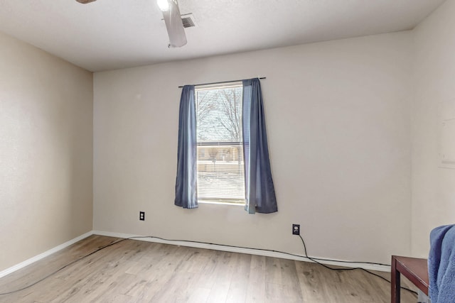 spare room featuring ceiling fan and light hardwood / wood-style floors