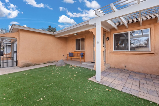 exterior space featuring a yard, a patio, and a pergola