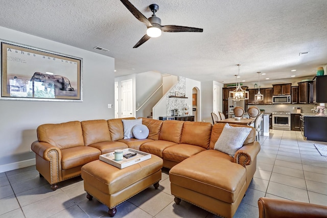 living room featuring light tile patterned floors, visible vents, arched walkways, and a ceiling fan