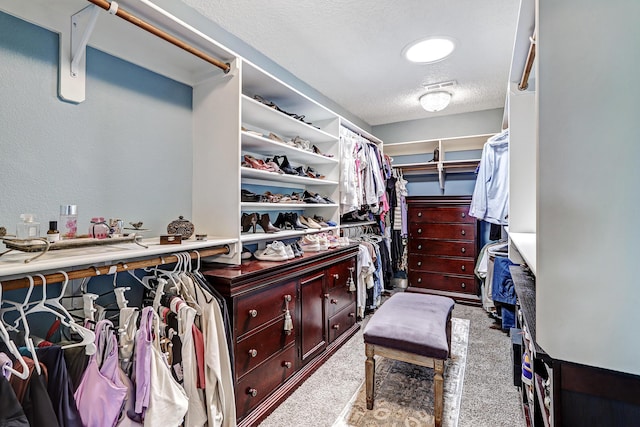 walk in closet with light carpet and visible vents