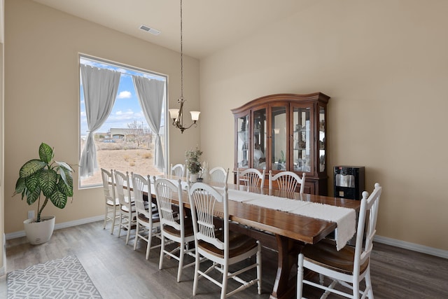 dining room featuring a chandelier and wood-type flooring